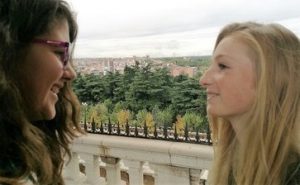 Immersion: One Spanish student looking at her friend coming for a Spanish inmersion in Madrid