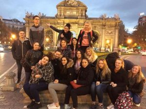 School trip in Madrid: students in front of Puerta de Alcalá